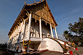 Vientiane, Laos - Pha That Luang, the elegant structure, Wat That Luang Neua, with a very ornate front faade fronted by two tall standing Buddha statues. 